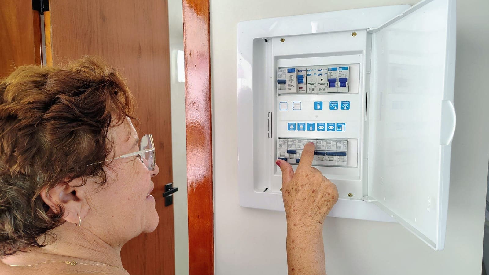 An electrical panel and breaker box mounted in a basement.